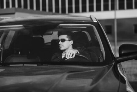 Handsome man in glasses driving carの写真素材