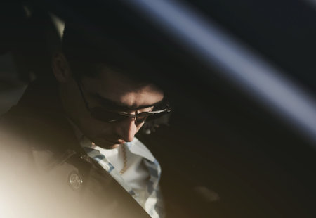 Confident man driving a car. Business and success