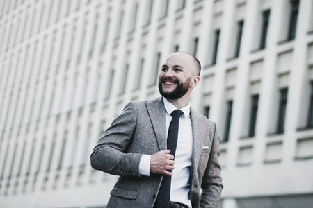 Portrait of a smiling businessman. Happy man posing in cityscape.の写真素材