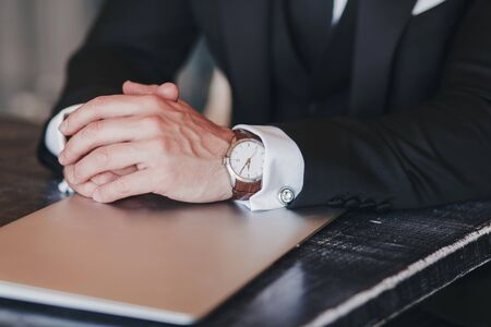 close-up of the hands of a successful man with a watch and laptop. business conceptの写真素材