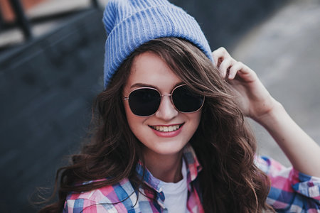 Beautiful young hipster woman smiling in urban background. Girl wearing casual clothes in the street.の写真素材