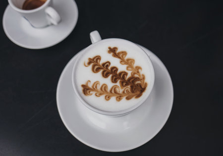 two mugs of coffee on the table. cappuccino with milk foam and espresso