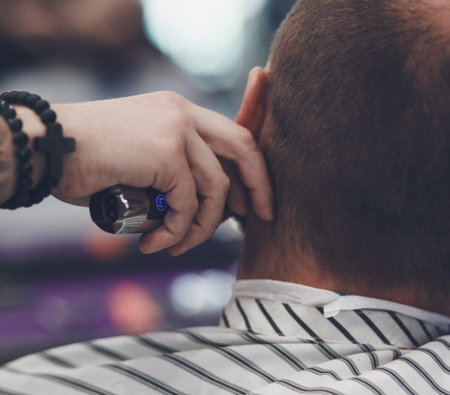 Haircut men Barbershop. Barber cuts the client machine for haircuts.