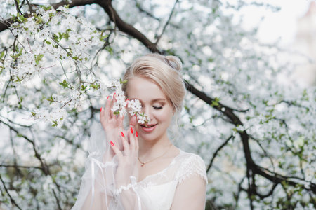 Bride.Young fashion model with hairstyle and make up holding flowersの写真素材