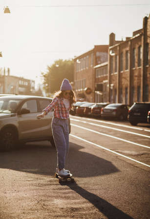 Hipster woman with a skateboard in the sunny day. Freedom and independence youth conceptの写真素材
