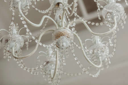 majestic vintage chandelier hangs from the ceiling in an old interiorの写真素材