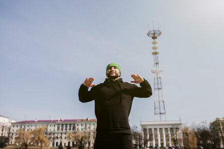 Full length portrait of a athletic man stretching in the morning park