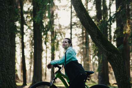 Young woman traveling with bicycle in park. healthy active lifestyle travelerの写真素材