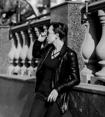 fashion portrait of a stylish elegant woman in sunglasses and leather jacketの写真素材