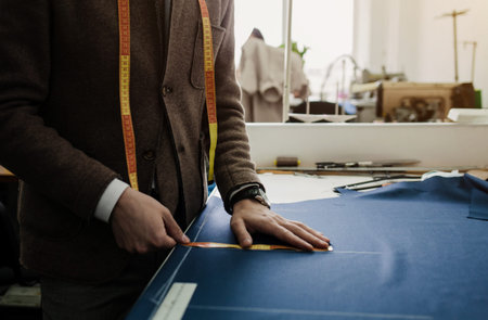 the tailor marks the lines on the clothes with chalk. private tailoring business