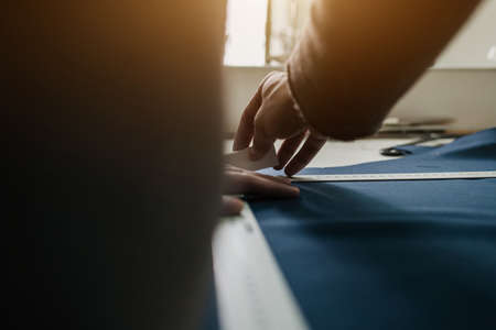 the tailor marks the lines on the clothes with chalk. private tailoring businessの写真素材
