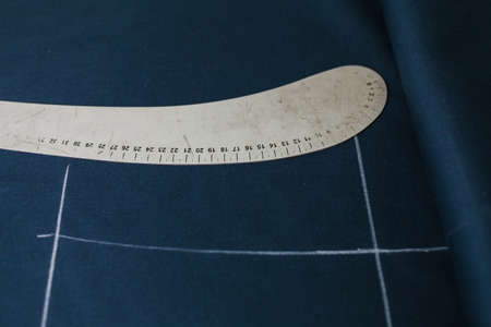 man on sewing machine and item of clothing, old sewing machine, vintage styleの写真素材