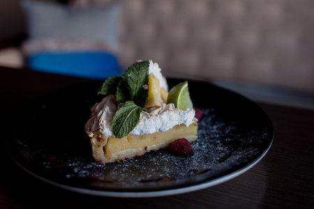 A piece of cake with mint on the table, close-up