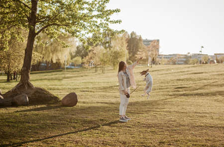 Young beautiful woman relaxing with dog in park. summer style conceptの写真素材