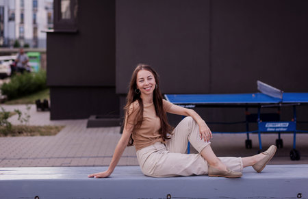 stylish smiling woman in trousers and stylish leather shoes on the street