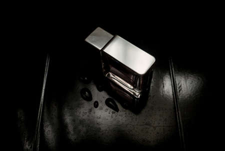 black fragrance perfume bottle on wood background. Top view.の写真素材
