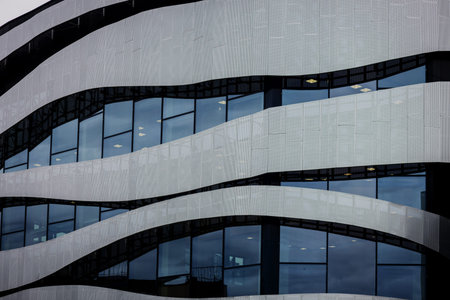 Futuristic silver architecture. Modern office building with metallic elements