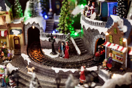 Traditional miniature christmas - happy people near christmas treeの写真素材