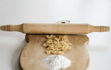 organic food. raw pasta, eggs and flour on a wooden boardの写真素材