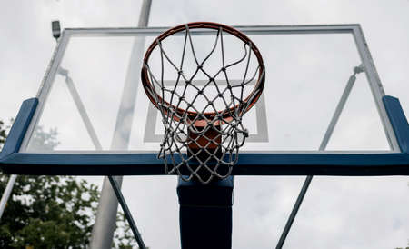 Basketball Shield with a ring in the backyard. Home yard with basketball court.の写真素材