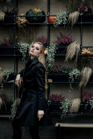 portrait of young elegant smiling woman wearing black coatの写真素材