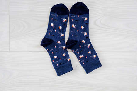 pair of bright socks with a pattern on a light wooden background. socks for men and womenの写真素材