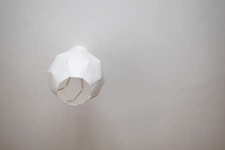 elegant plastic lamp hanging on ceiling. copyspace. modern interiorの写真素材