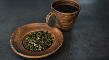 scattered fragrant black coffee on a dark background. coffee beans and cinnamon sticksの写真素材