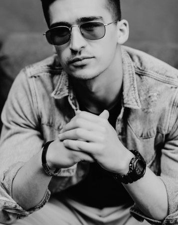 fashionable man in glasses and casual clothes looking at the camera. street styleの写真素材