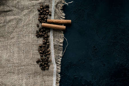coffee beans and cinnamon on natural burlap textureの写真素材