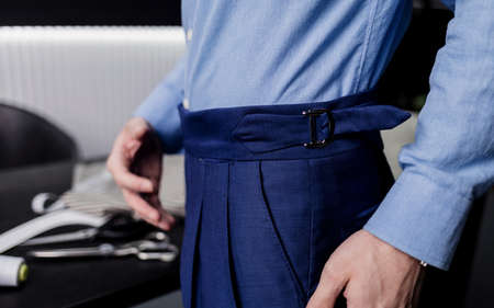 Tailor man working in his tailor shop. the master of tailoring in the workshop outlines the cutting linesの写真素材
