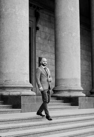 businesspeople. confidence businessman in suit. a successful manager in a jacket on the background of an office buildingの写真素材