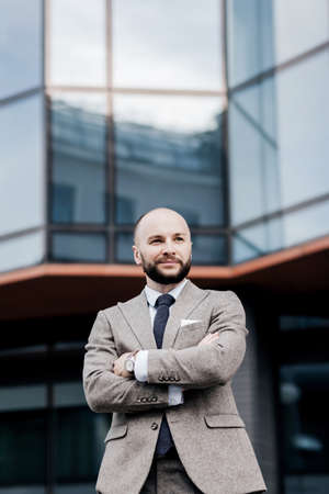 businesspeople. confidence businessman in suit. a successful manager in a jacket on the background of an office buildingの写真素材