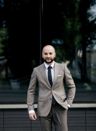 successful manager. handsome man in a suit is sitting in the officeの写真素材