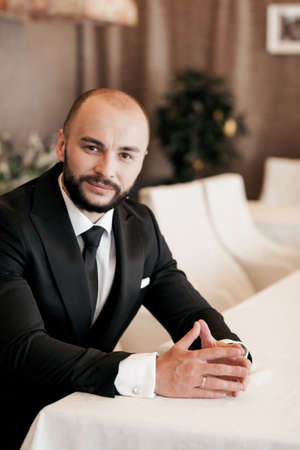 successful manager. handsome man in a suit is sitting in the officeの写真素材