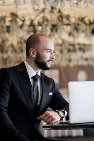 successful manager. handsome man in a suit is sitting in the officeの写真素材