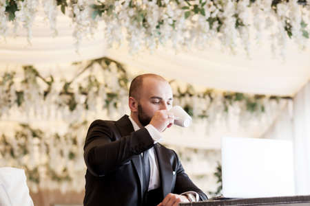 successful manager. handsome man in a suit is sitting in the officeの写真素材