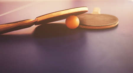 two tennis rackets and a ball on the table.の写真素材