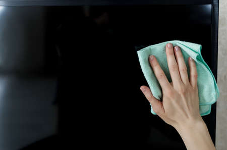 Hand Cleaning Television With Cloth At Home. cleaning service.の写真素材