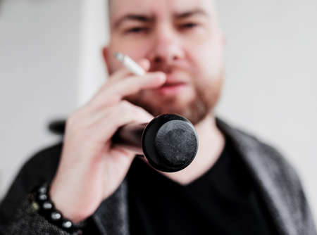 photo of bearded guy smoking cigarette. bad habitsの写真素材