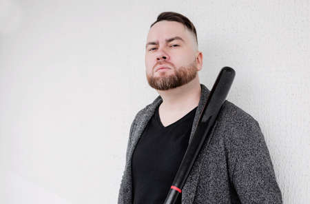 dangerous bearded man with black bat. macho hair cutの写真素材