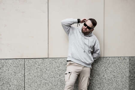 bearded man in gray blank hoodie. mockup for print. urban settingの写真素材