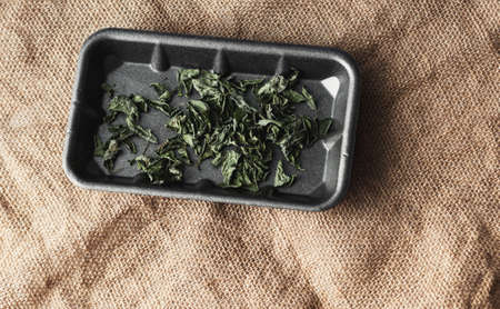 dried mint leaves on burlap. top view, flat lay. Mint for medicinal tea.の写真素材