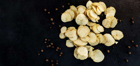 potato chips with pepper grains stone stone background. top view.の写真素材