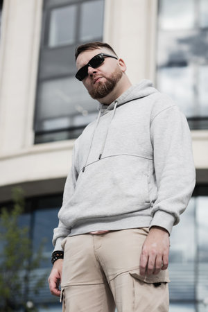 Vaping man holding a mod. A cloud of vapor. Stylish bearded guy with vape.の写真素材