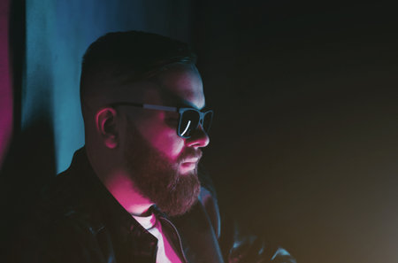 Vaping man holding a mod. A cloud of vapor. Stylish bearded guy with vape.の写真素材