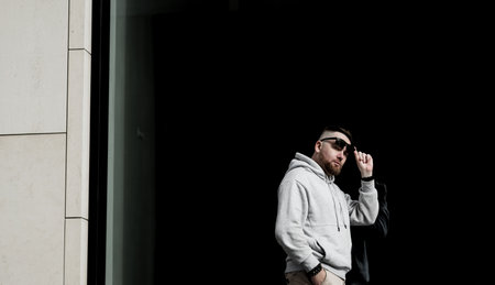 portrait of handsome hipster model. Stylish man dressed hoodie. Fashion male model in sunglassesの写真素材