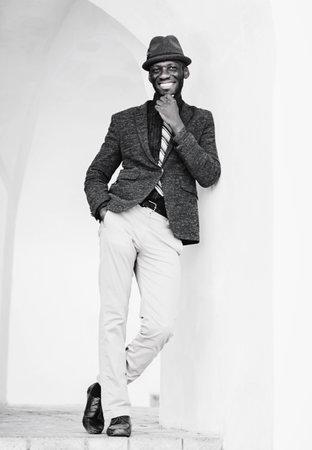 smiling cheerful african american man in suit and hatの写真素材