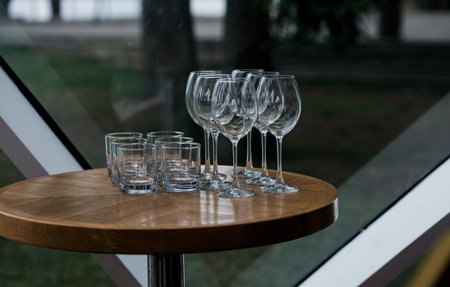 empty wine glasses and whiskey on the table. preparation for the weddingの写真素材