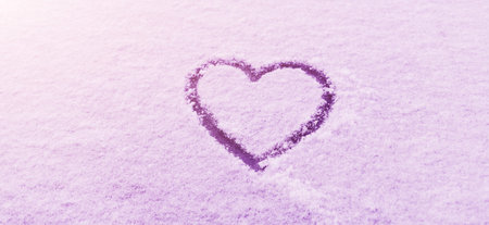 Heart symbol drawn on the snow, on winter day. Romance. Valentine's Day.